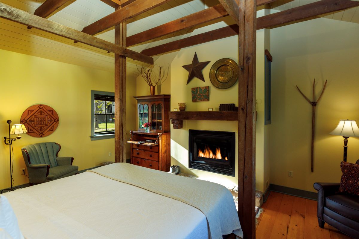 a room with a bed and fireplace