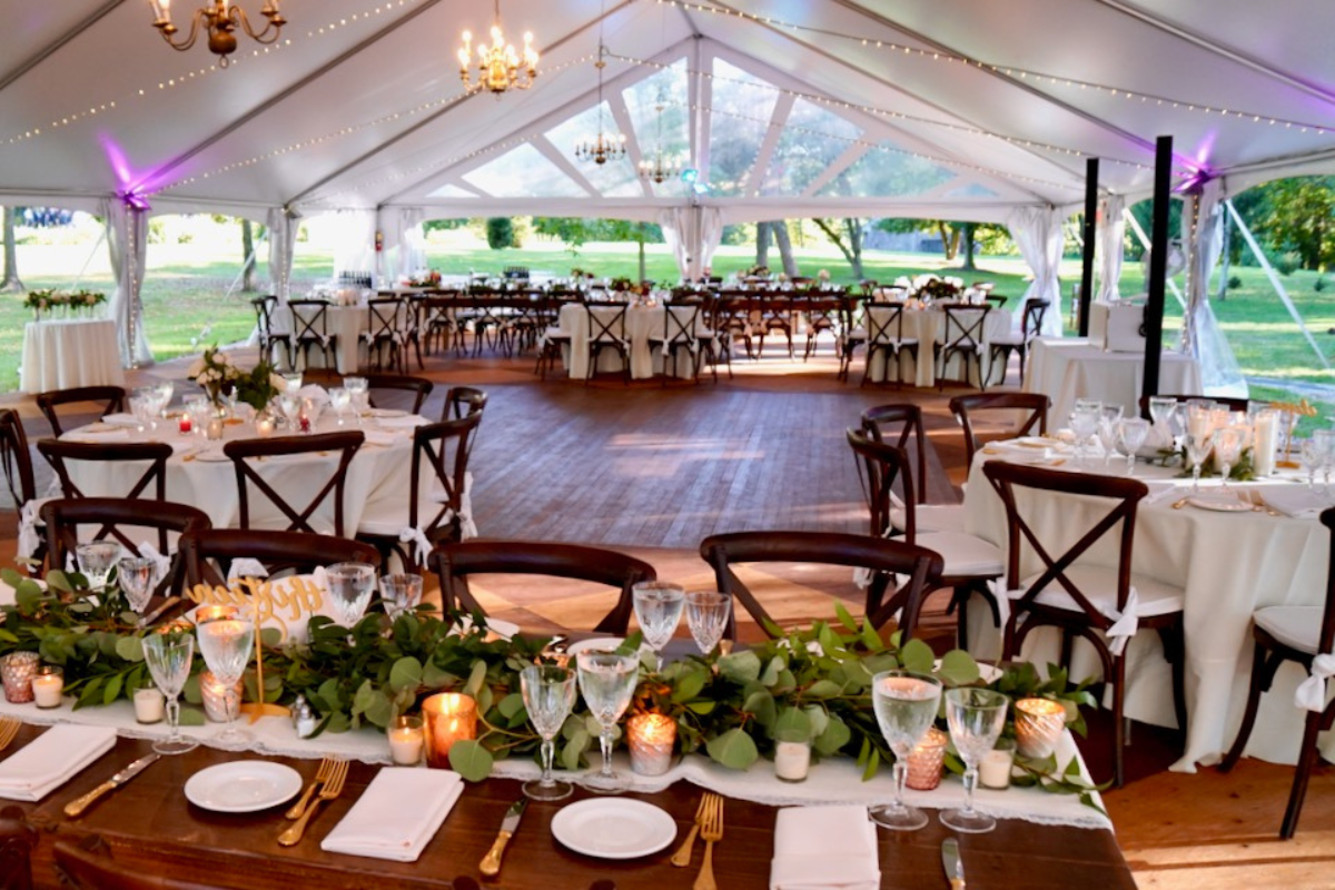 a large tent with tables and chairs