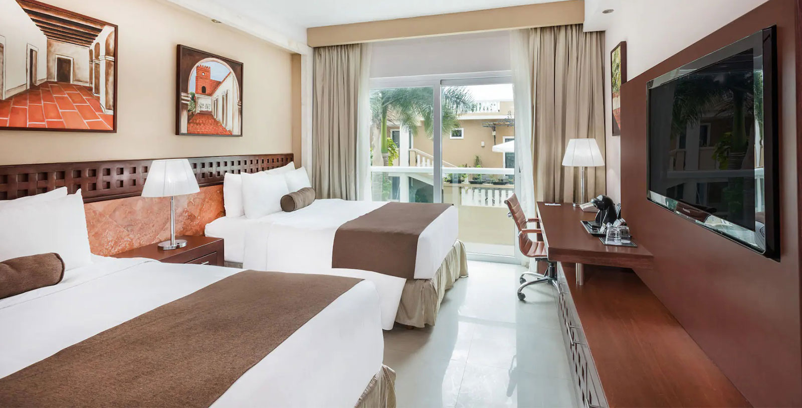 a room with two beds and a desk