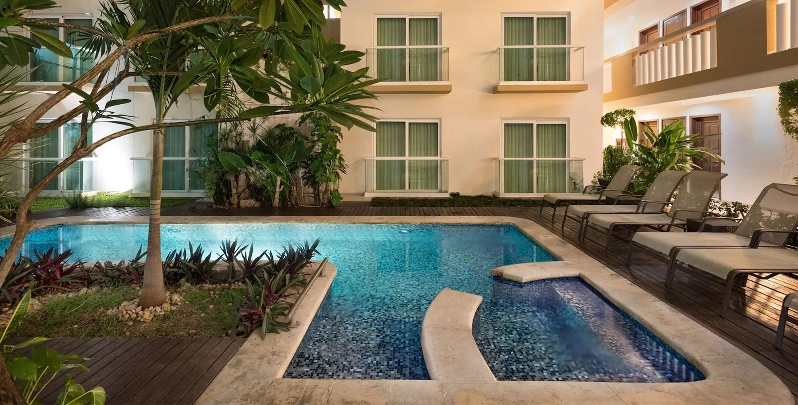 a swimming pool with a bench in the back