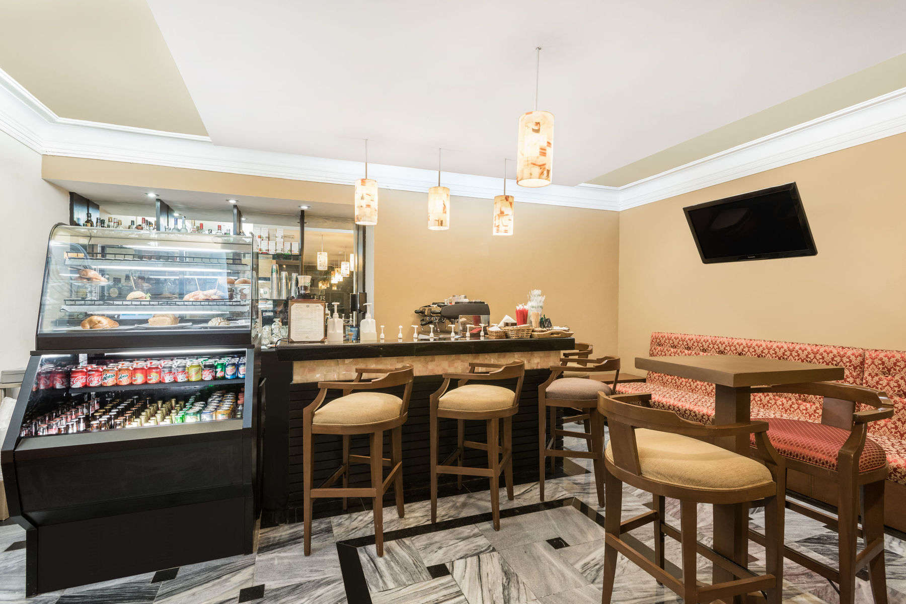 a coffee shop with a counter and stools