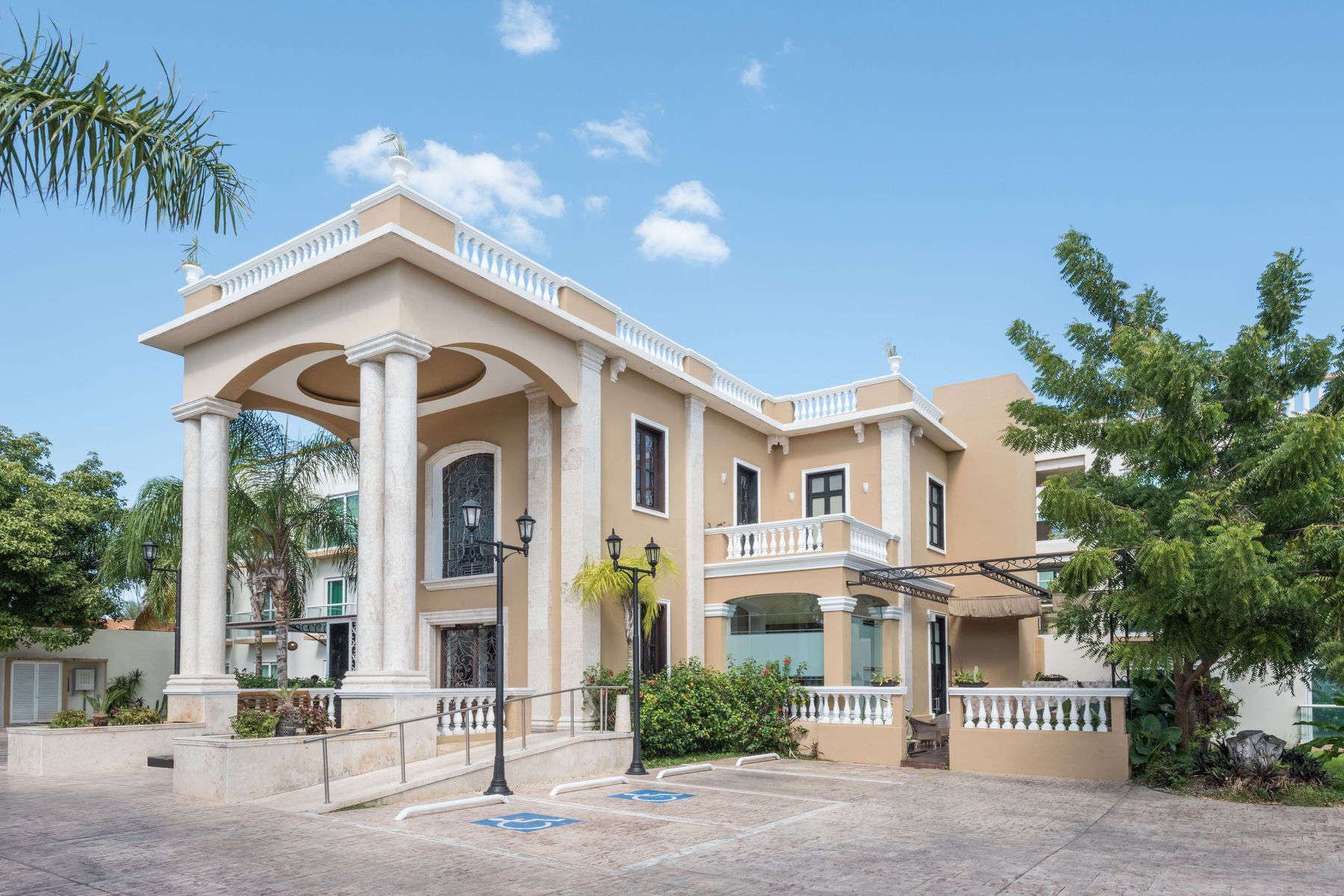a building with columns and a parking lot