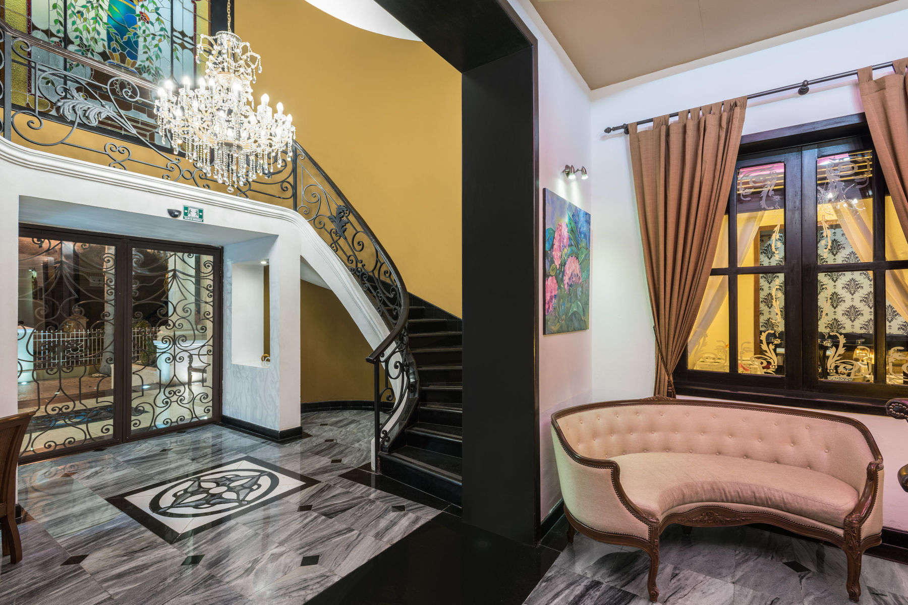 a staircase with a couch and chandelier
