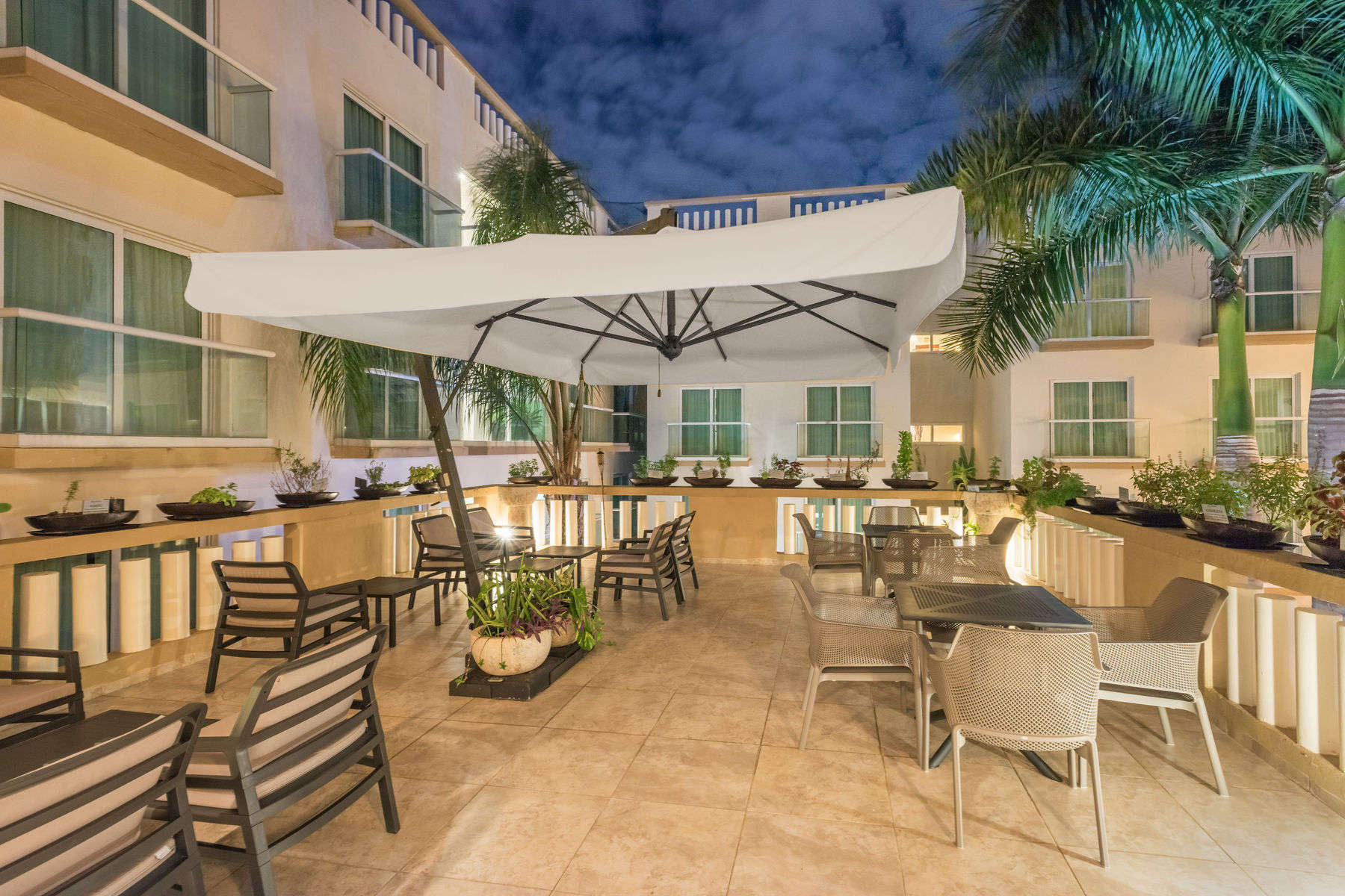 a patio with chairs and umbrella
