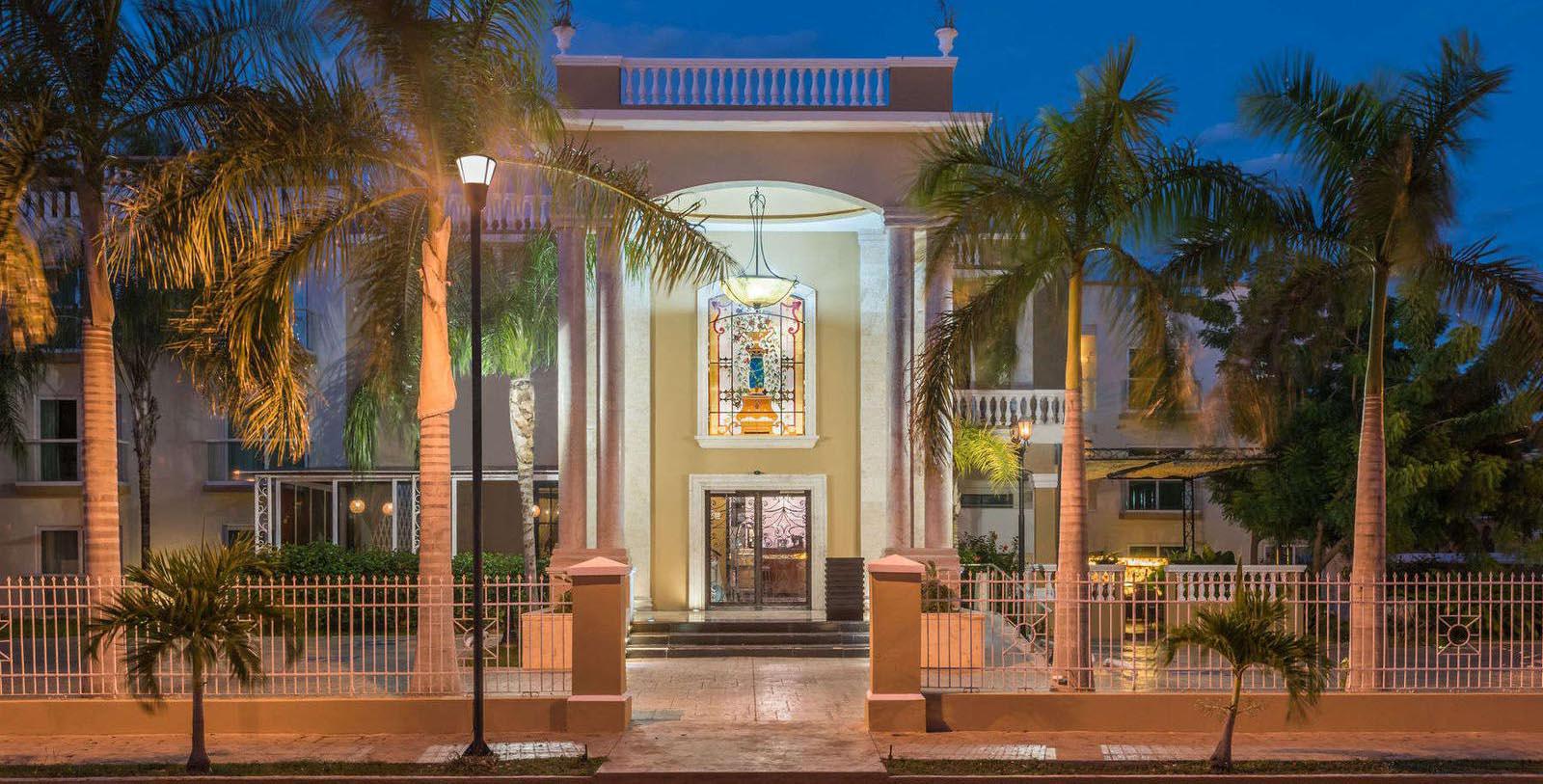 a building with palm trees in front of it