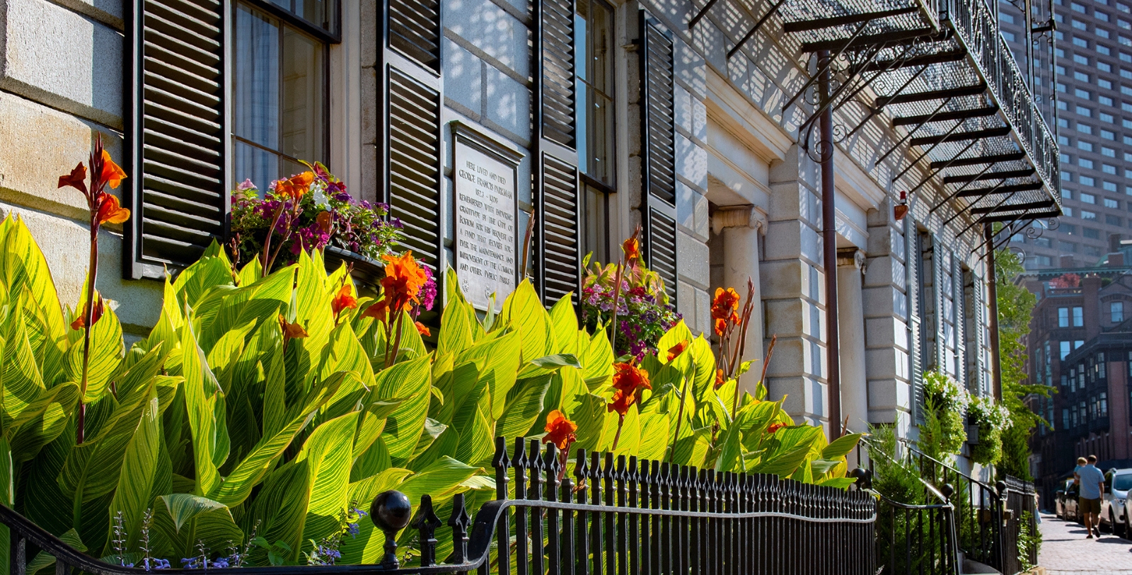 a fence with flowers and a sign on it