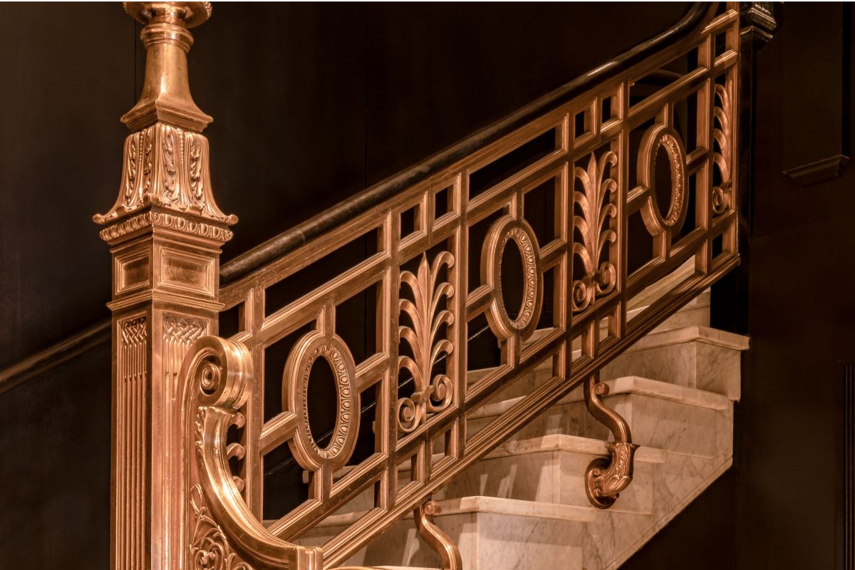 a gold railing on a staircase