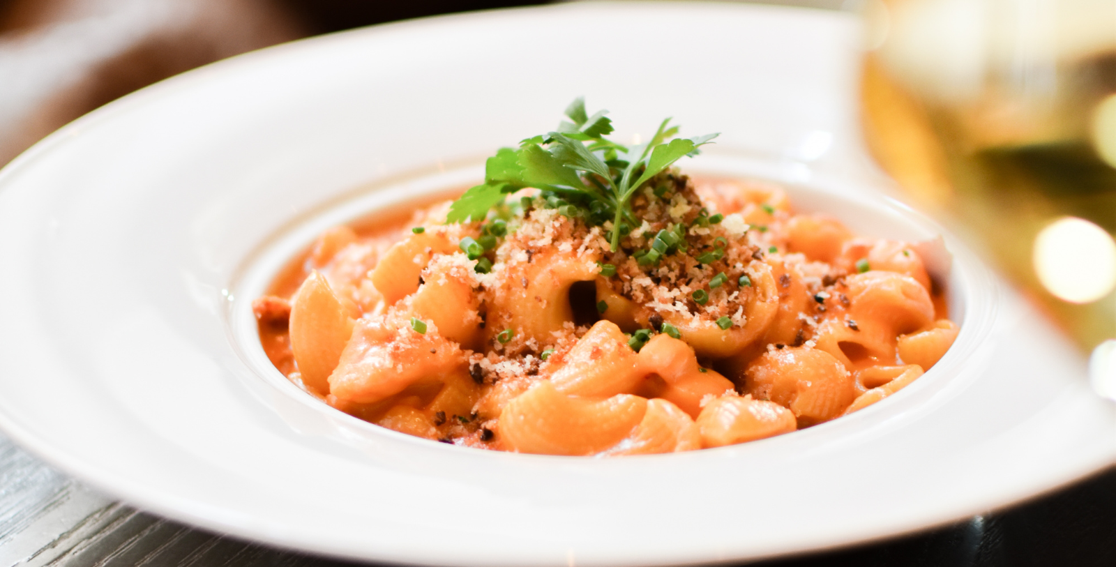 a plate of pasta with parsley on top