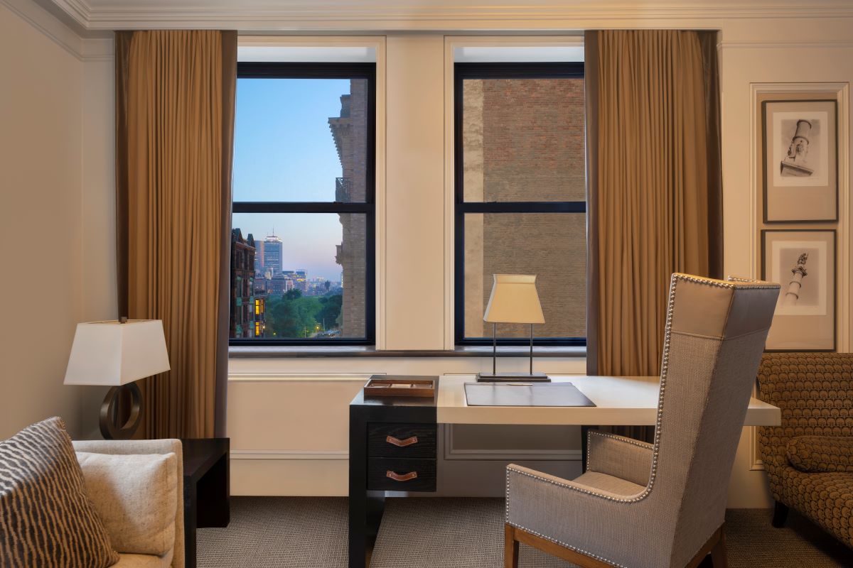 a desk and chair in a room with curtains