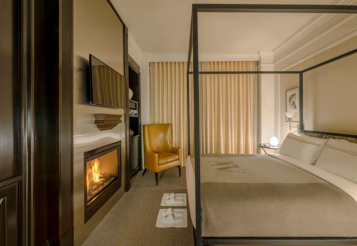 a room with a bed and fireplace