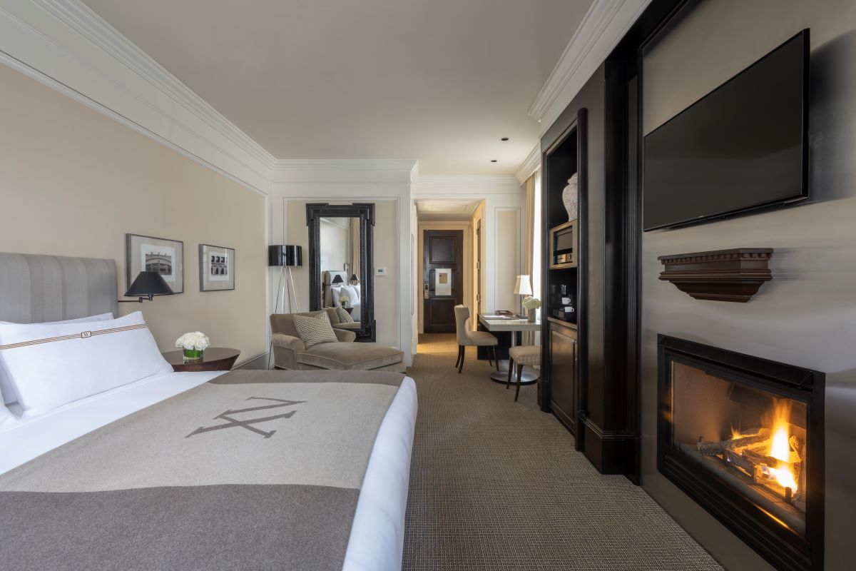a room with a bed and fireplace