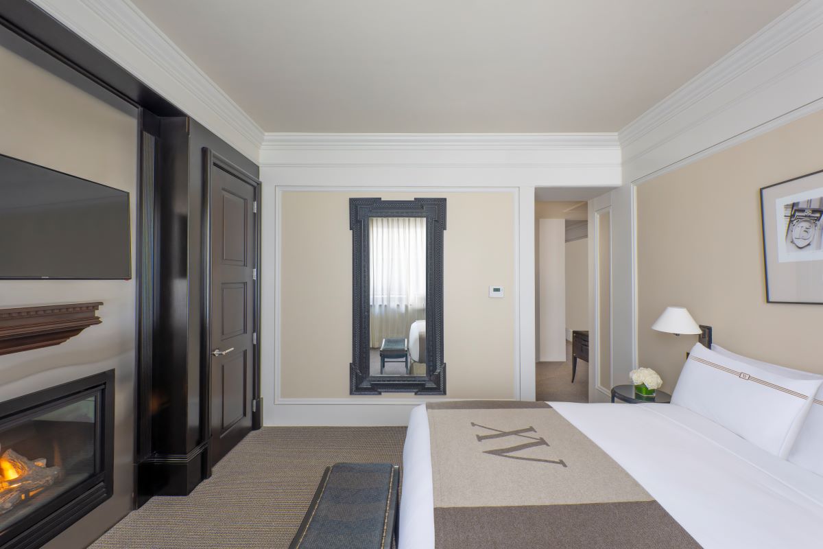 a bedroom with a mirror and a bed