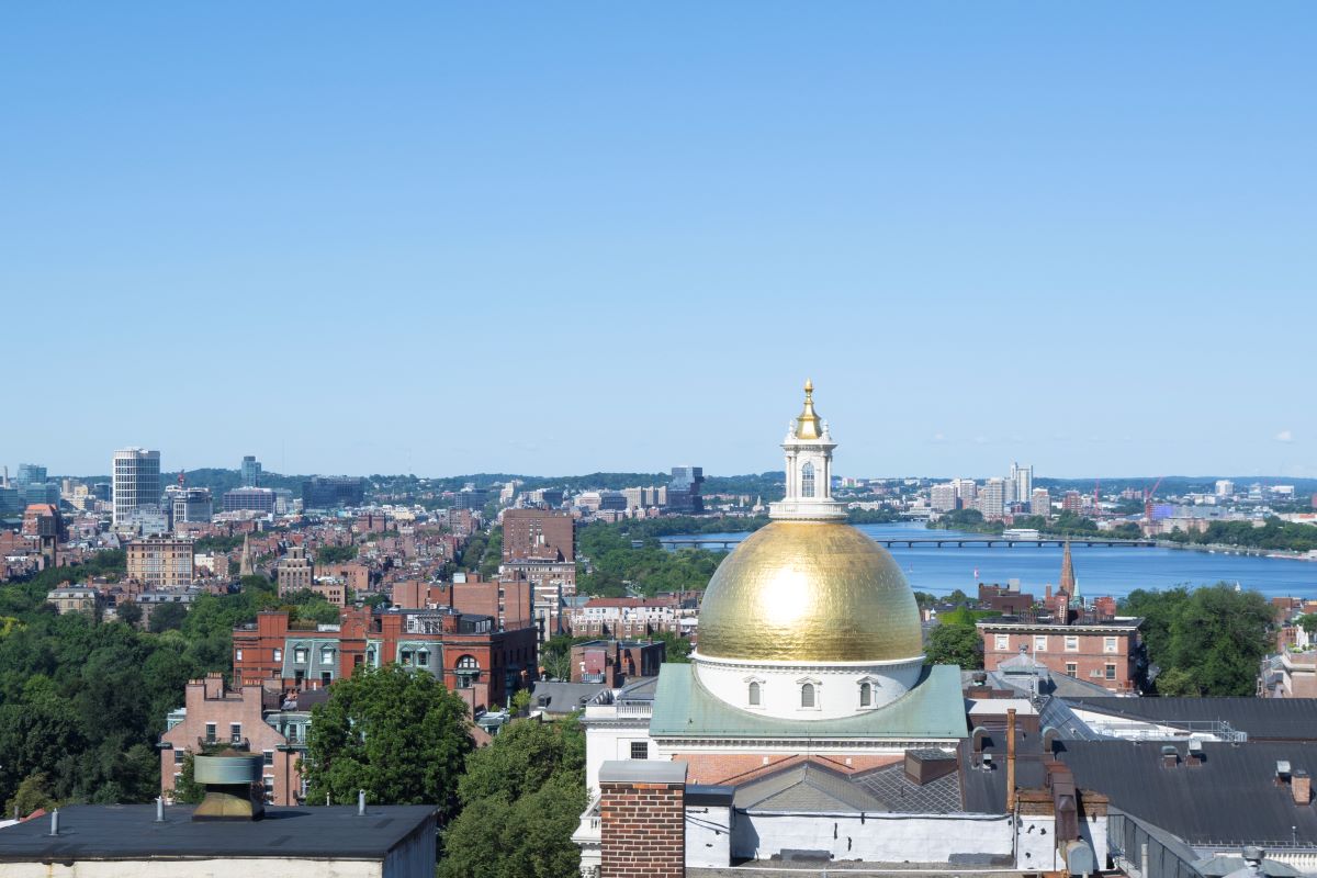 a city with a gold dome and a river in the background