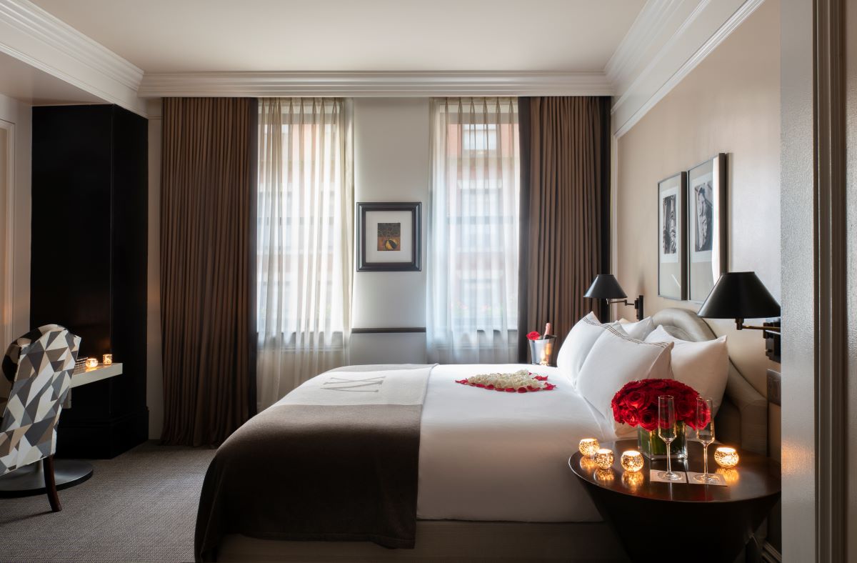 a bedroom with a bed and flowers on it