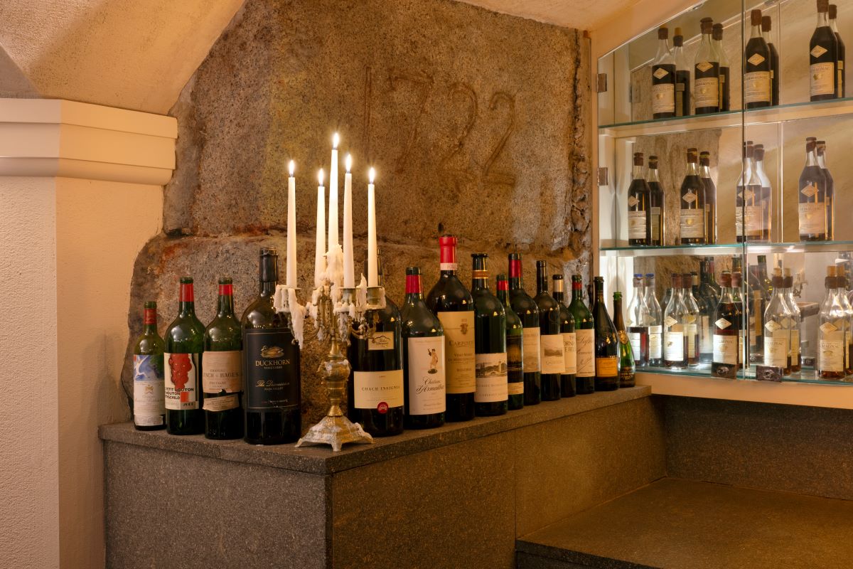 a group of wine bottles with candles on top of each other