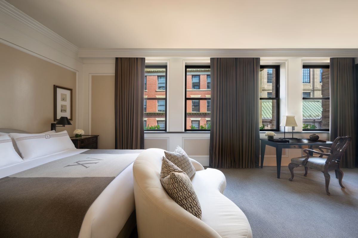 a bedroom with a bed and a desk
